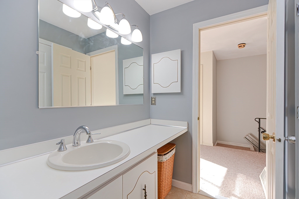 23 Tamarack Lane, Unit 23 Peabody, MA 01960 - Photo 29 of 42 a bathroom with a sink and a mirror