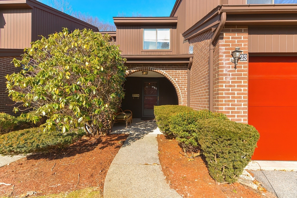 23 Tamarack Lane, Unit 23 Peabody, MA 01960 - Photo 3 of 42 a front view of a house with a garden