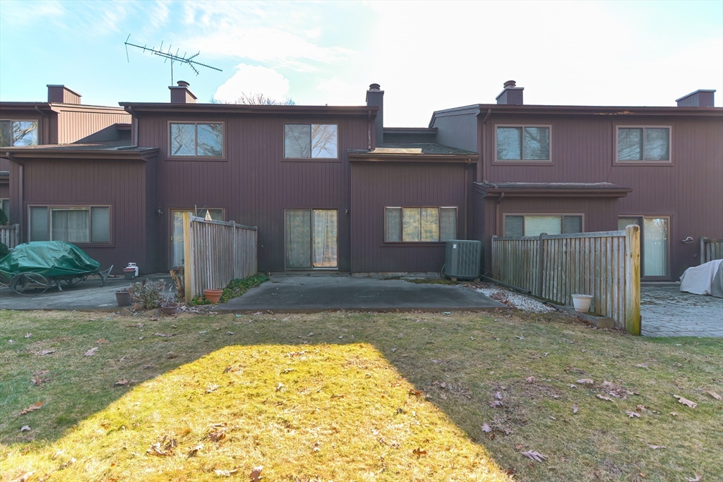 23 Tamarack Lane, Unit 23 Peabody, MA 01960 - Photo 32 of 42 a view of a brick house with a yard