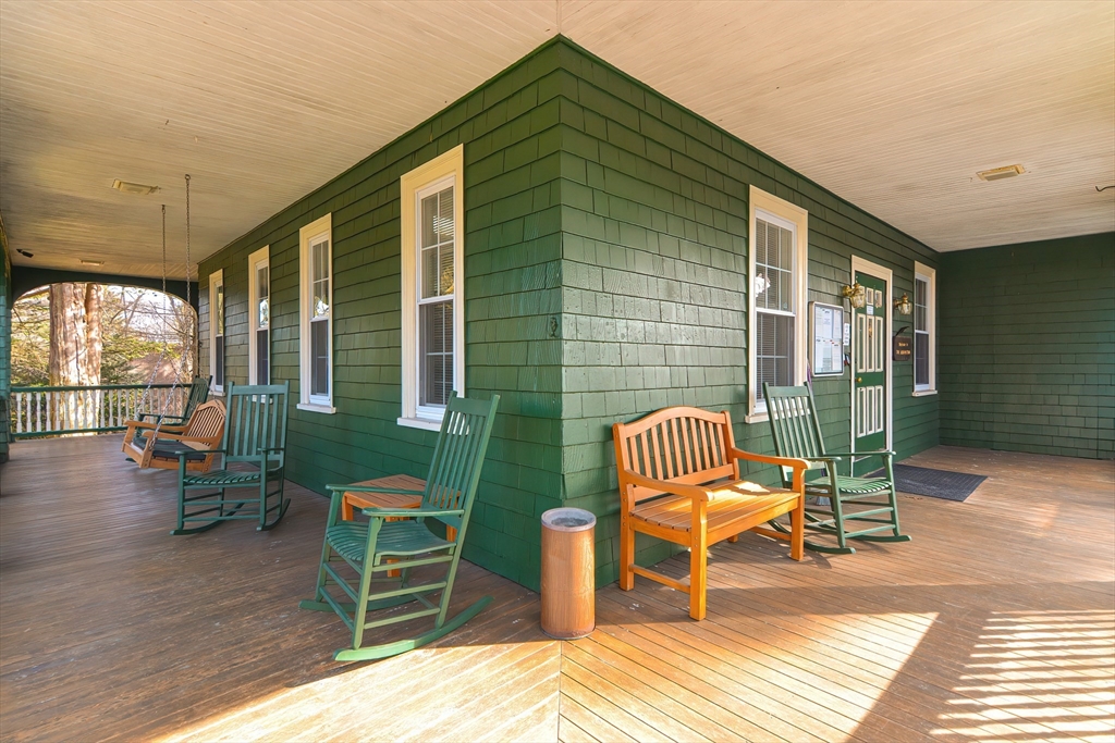 23 Tamarack Lane, Unit 23 Peabody, MA 01960 - Photo 36 of 42 a balcony with chairs and wooden floor