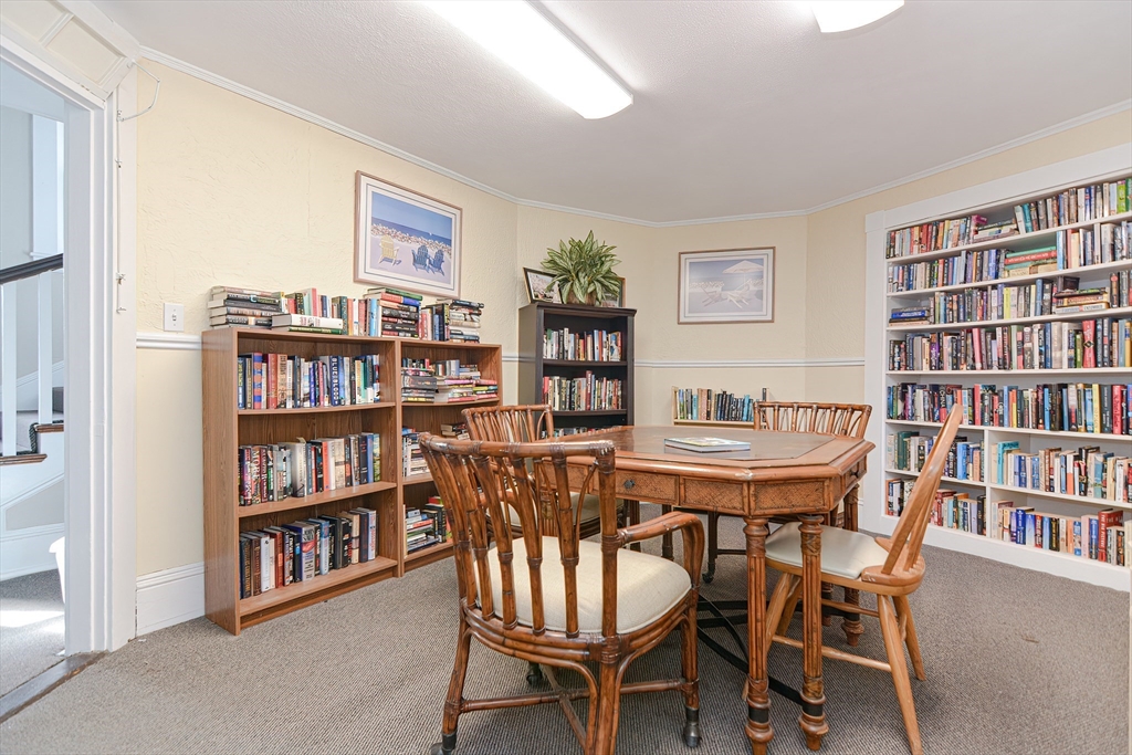 23 Tamarack Lane, Unit 23 Peabody, MA 01960 - Photo 39 of 42 a view of a livingroom with furniture and a bookshelf