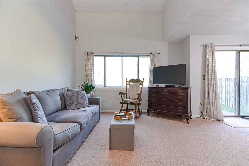 23 Tamarack Lane, Unit 23 Peabody, MA 01960 - Photo 5 of 42 a living room with furniture and a flat screen tv