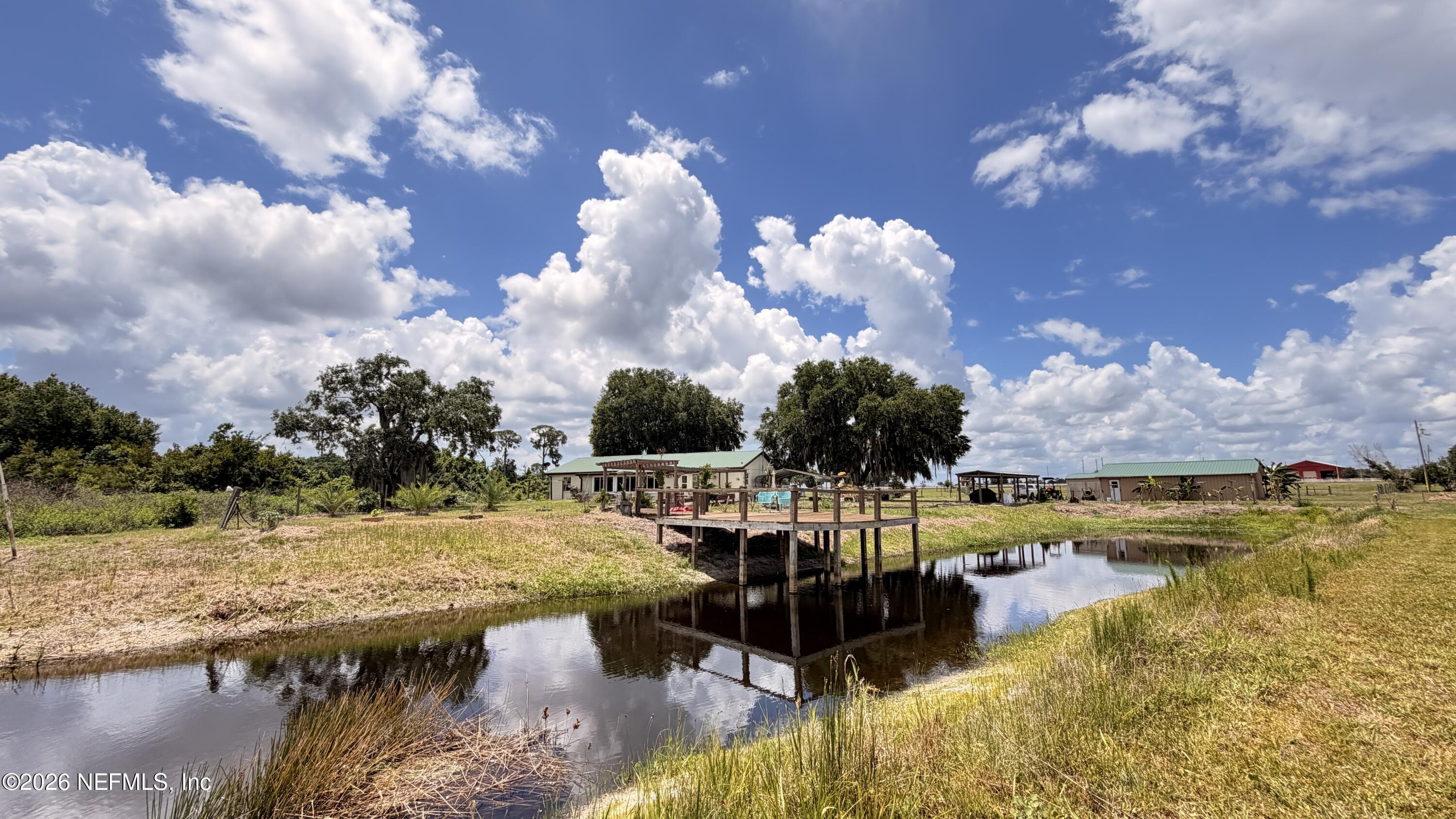 1360 Fort Meade Road Frostproof, FL 33843 - Photo 7 of 17 a view of a lake with houses in the back