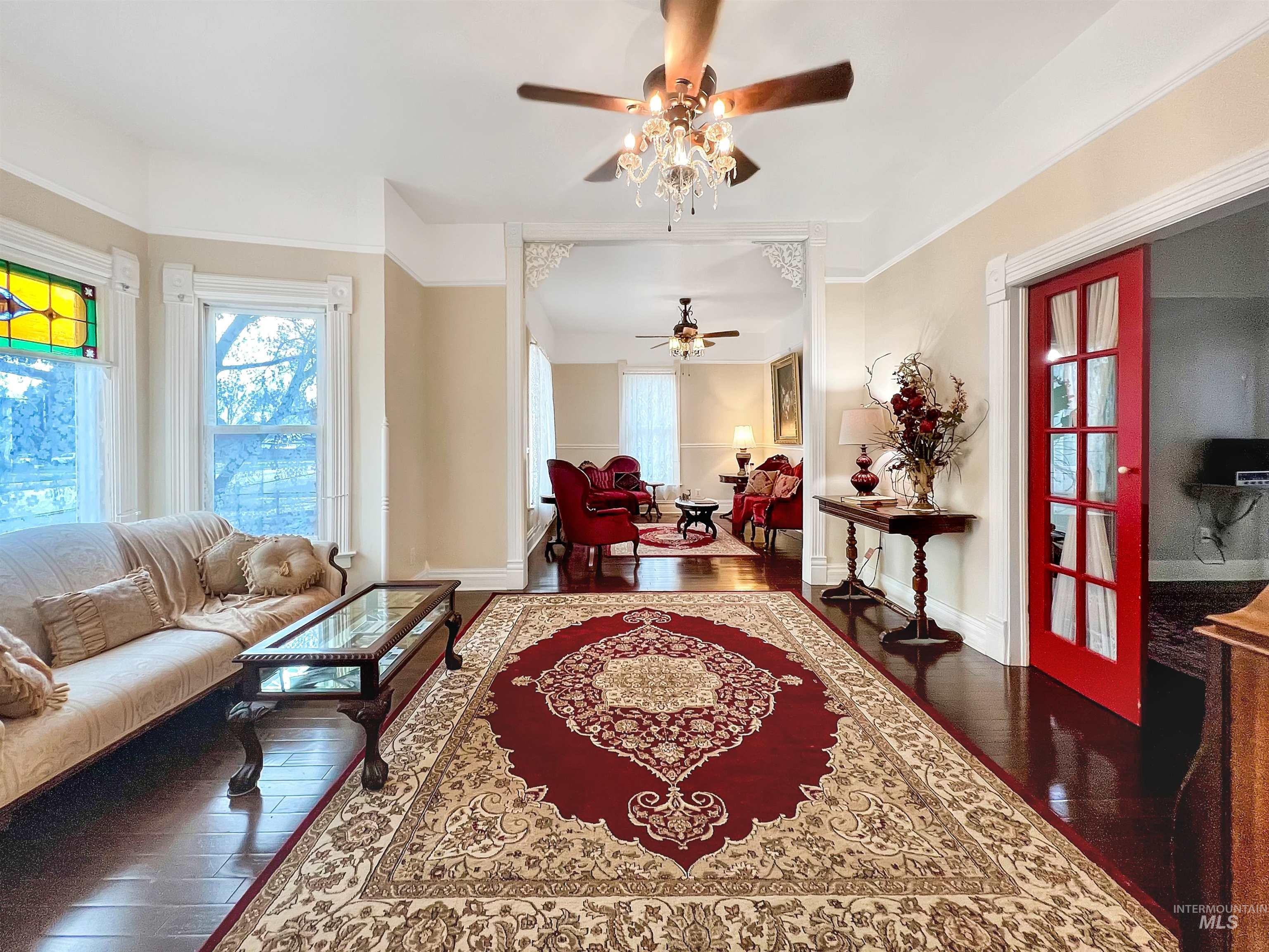 516 East Main Street Weiser, ID 83672 - Photo 13 of 50 Living area featuring dark wood-style flooring, healthy amount of natural light, and ceiling fan