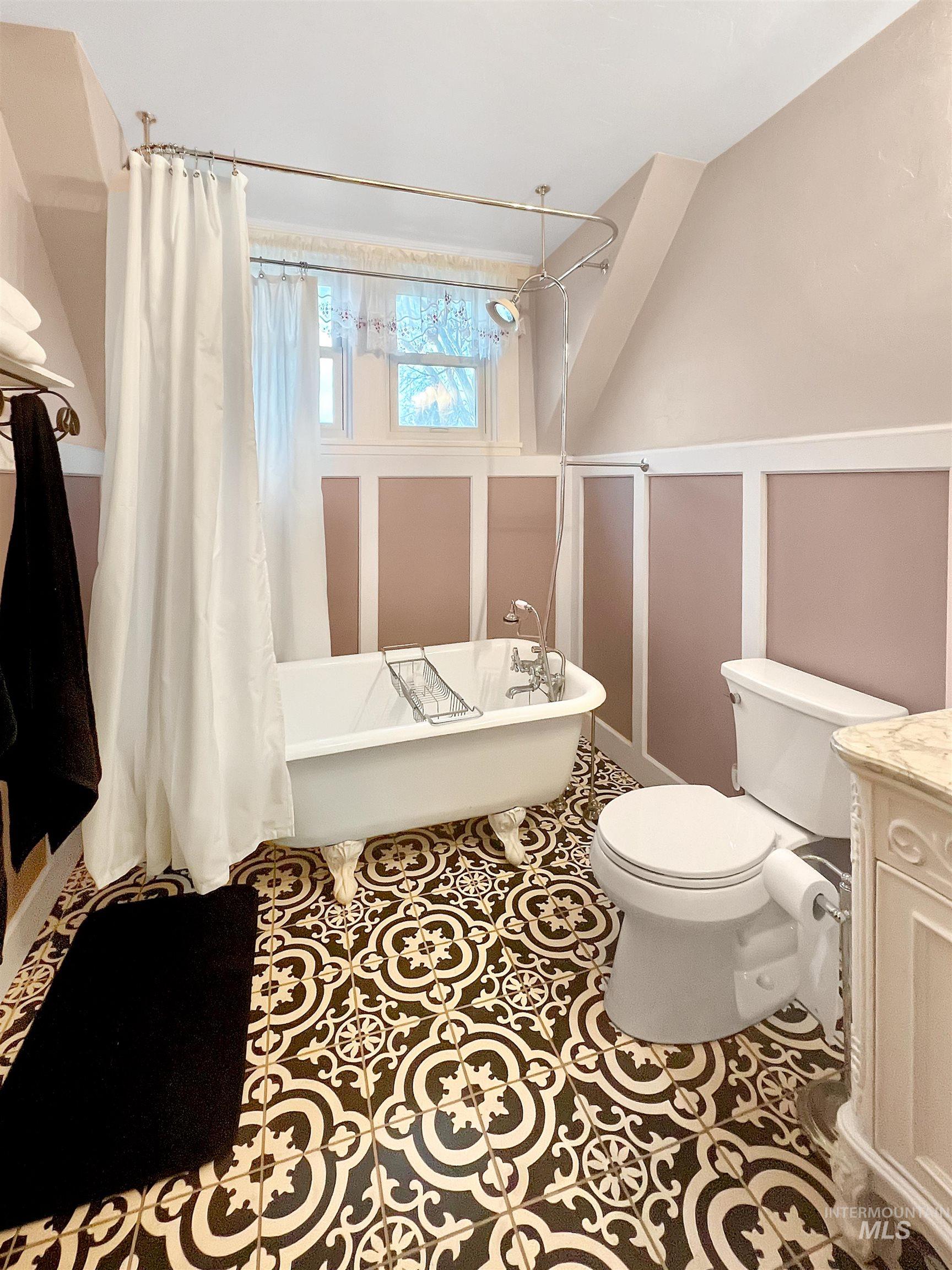 516 East Main Street Weiser, ID 83672 - Photo 33 of 50 Full bath featuring vanity, a combined bath / shower with freestanding tub, a decorative wall, and tile patterned floors
