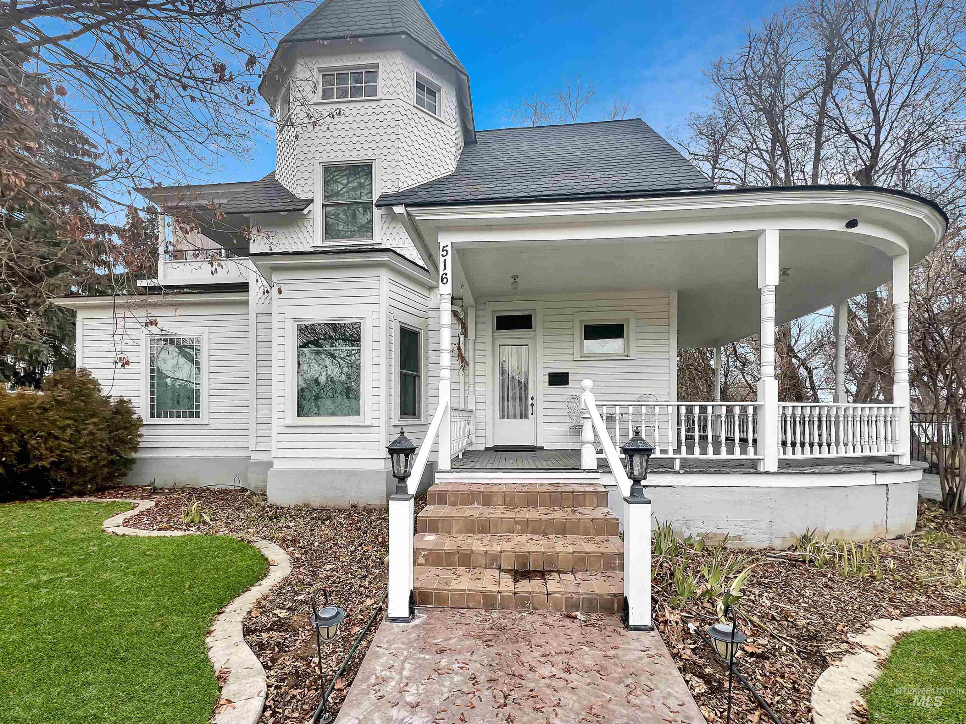 516 East Main Street Weiser, ID 83672 - Photo 6 of 50 Victorian house featuring covered porch, a shingled roof, and a front lawn