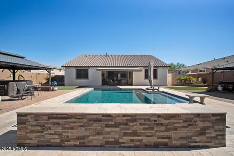a swimming pool with outdoor seating and living room