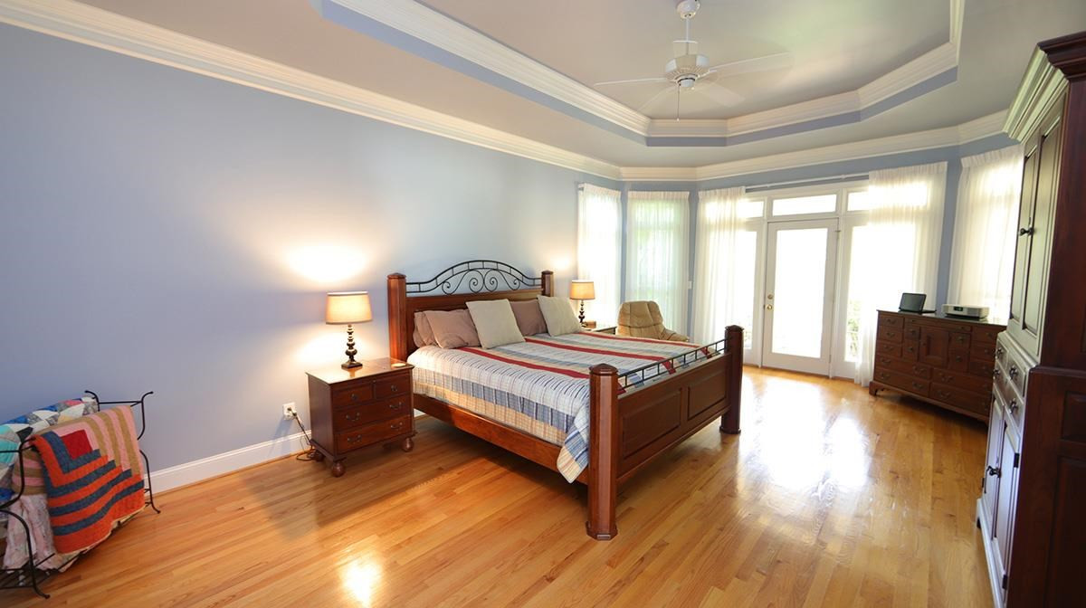 5817 Stone Spring Road Raleigh, NC 27613 - Photo 12 of 28 Owner's Suite Offers Double Trey Ceiling, Beautiful Hardwoods, Ceiling Fan and French Door Opening to Screened Porch. PLUS Newer Hardwoods in the Closets Owner's Suite
