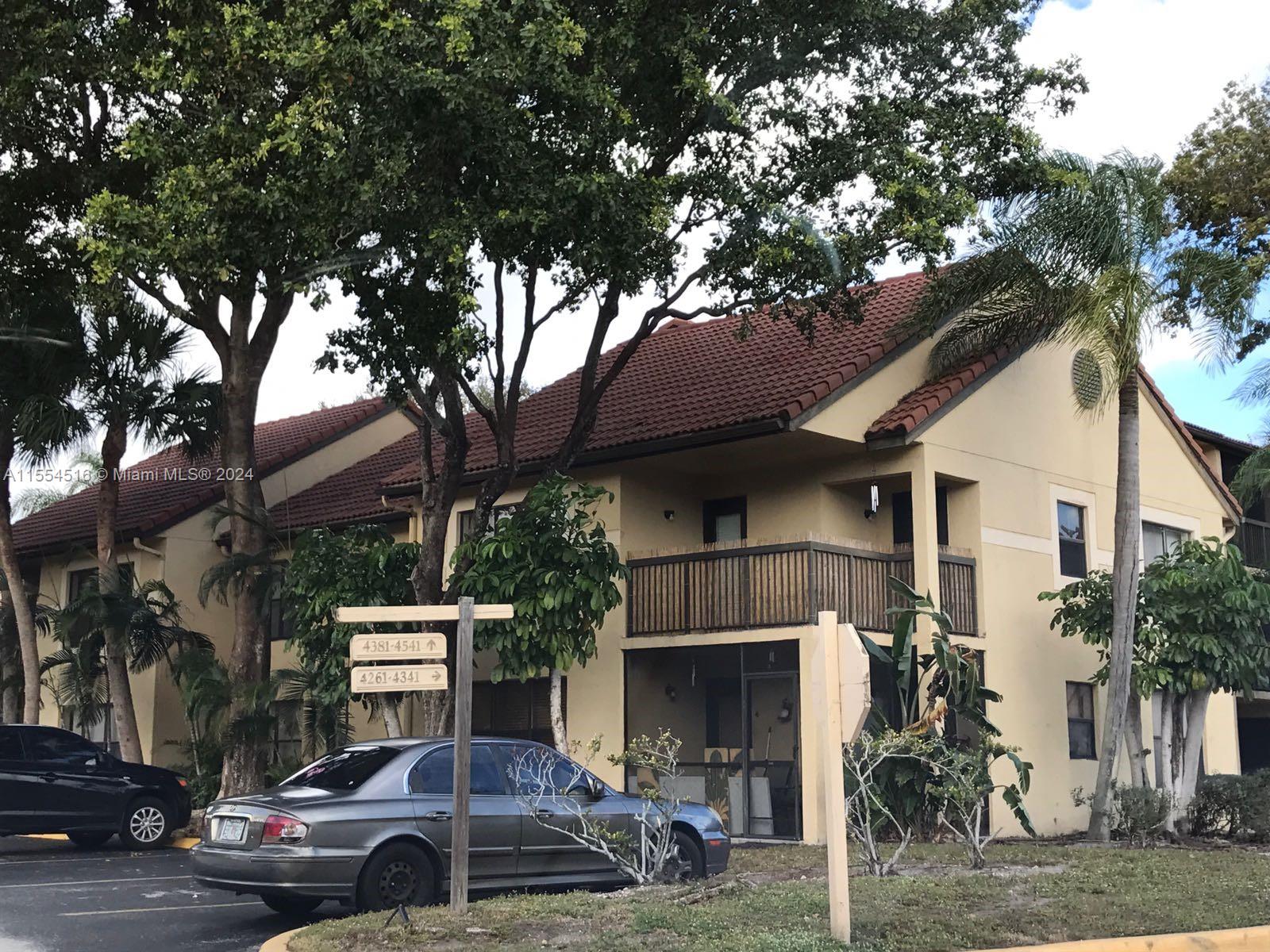 4241 West McNab Road, Unit 27 Pompano Beach, FL 33069 - Photo 24 of 29 a car parked in front of a building