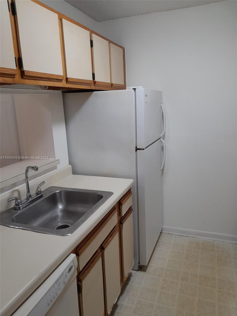 4241 West McNab Road, Unit 27 Pompano Beach, FL 33069 - Photo 6 of 29 a kitchen with a sink and washing machine