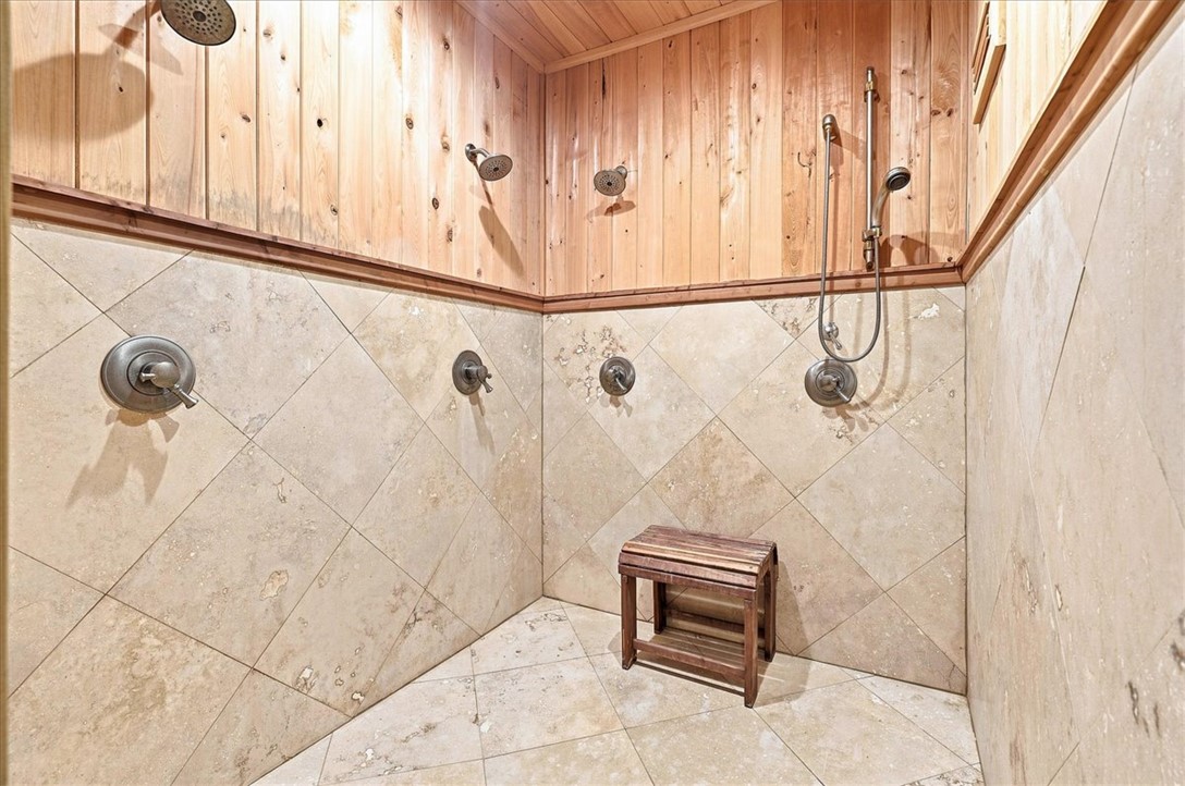 181 Sentell Road Williamston, SC 29697 - Photo 39 of 46 Lower level full bathroom with sauna and huge shower. Natural tile pairs with warm wood paneling in this custom multi-head shower.