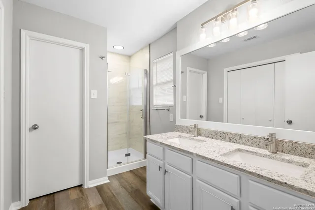 a bathroom with a granite countertop sink mirror and double