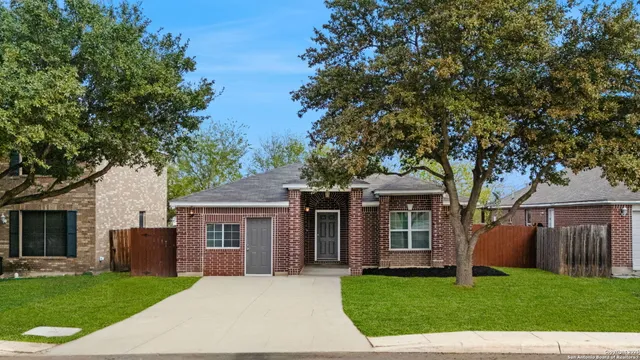 a front view of a house with a garden and yard