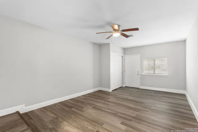 wooden floor in an empty room with a window
