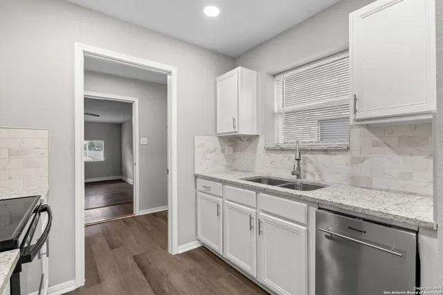 a kitchen with a sink cabinets and window