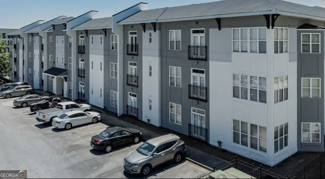 a couple of cars parked in front of a house