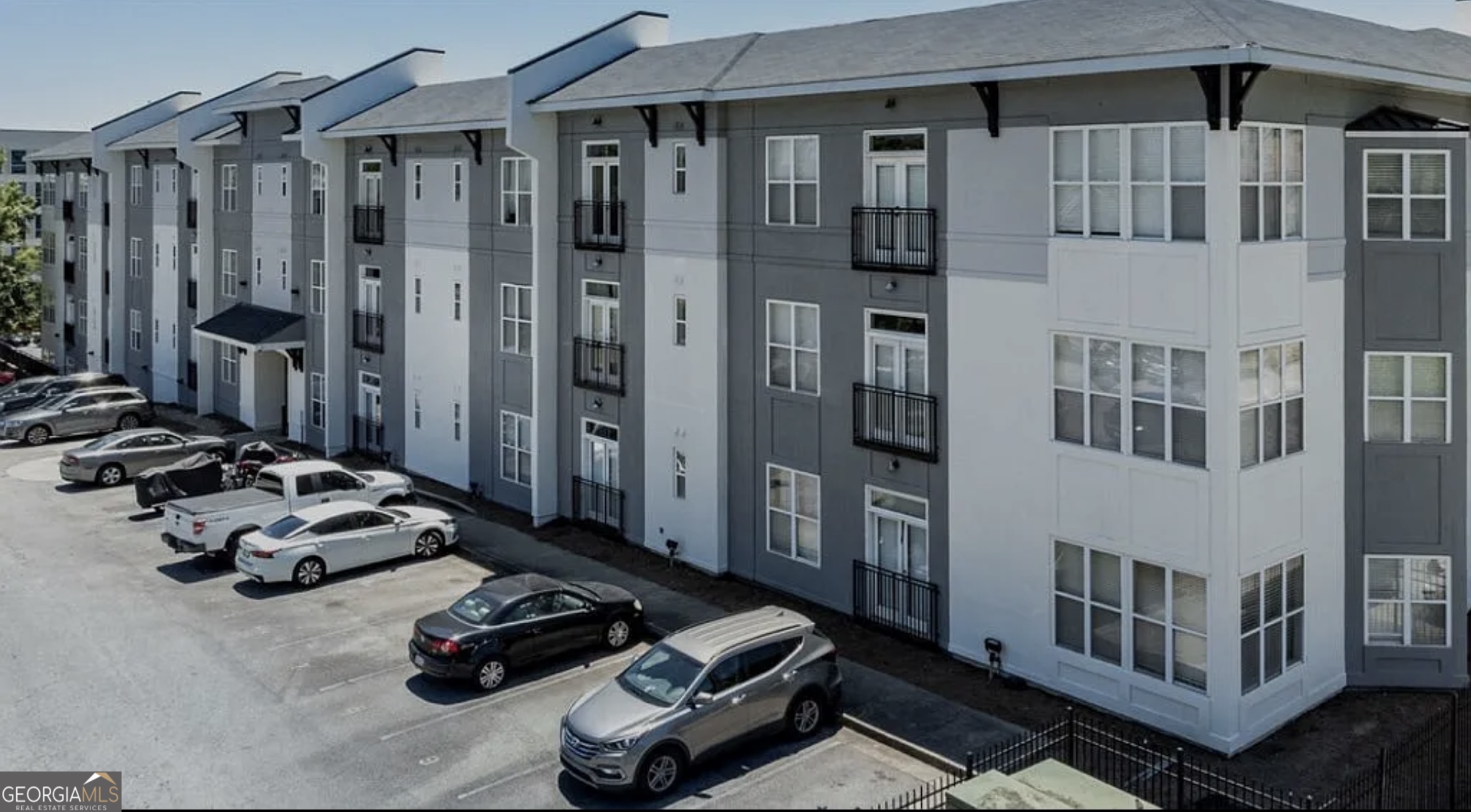 a couple of cars parked in front of a house