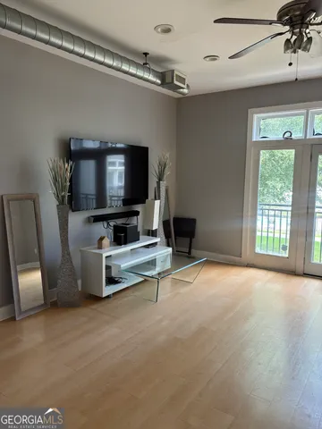 a living room with furniture and a flat screen tv