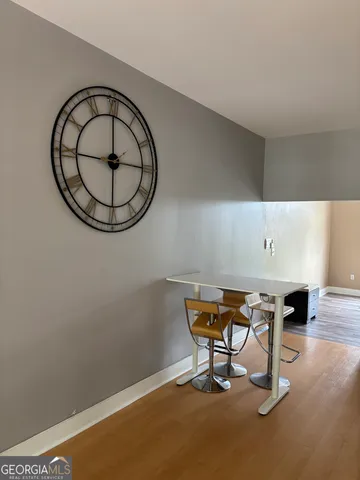 a view of a room with a table and chairs