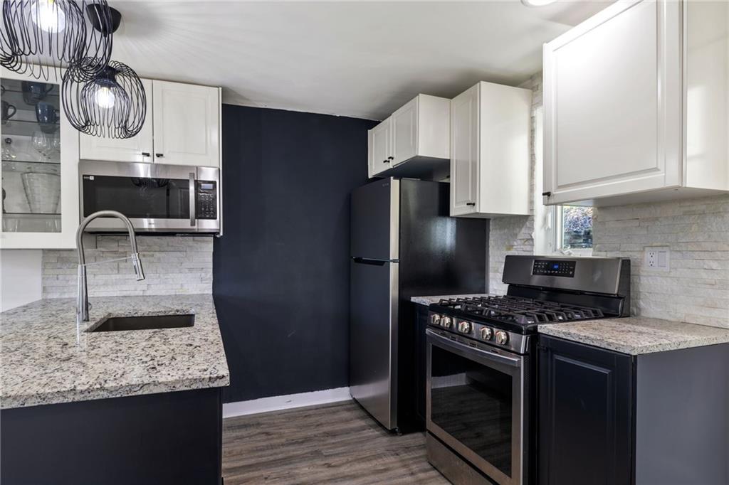 8144 Lincoln Road Verona, PA 15147 - Photo 14 of 33 a kitchen with stainless steel appliances granite countertop a sink stove and refrigerator