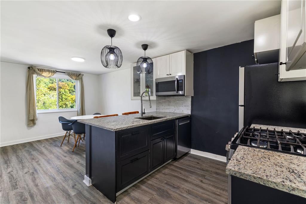 8144 Lincoln Road Verona, PA 15147 - Photo 15 of 33 a kitchen with a stove and a wooden floor