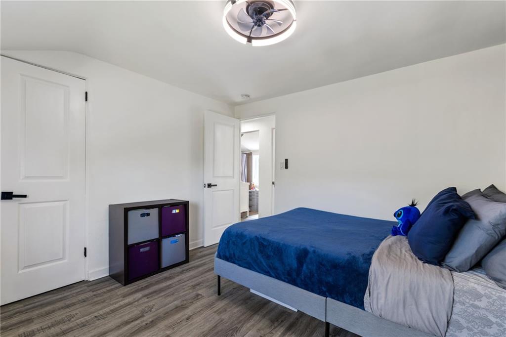 8144 Lincoln Road Verona, PA 15147 - Photo 20 of 33 a bedroom with a bed and a chandelier