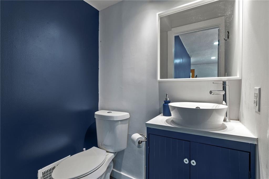 8144 Lincoln Road Verona, PA 15147 - Photo 9 of 33 a white toilet sitting next to a bathroom sink