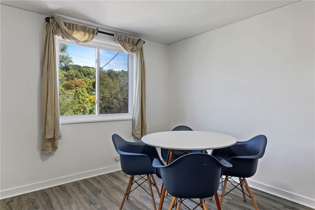 8144 Lincoln Road Verona, PA 15147 - Photo 10 of 33 a view of a dining room with furniture window and wooden floor