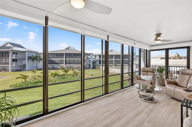 a bedroom with furniture and large windows