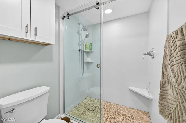 a bathroom with a shower and a toilet