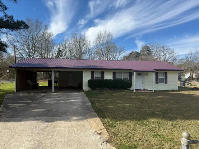 a view of a house with a yard and garage