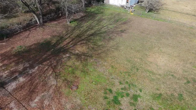 a view of a yard with large trees