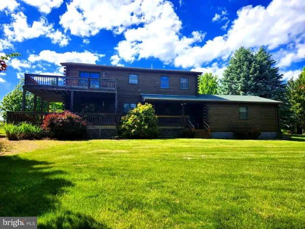 a view of a house with backyard porch and sitting area