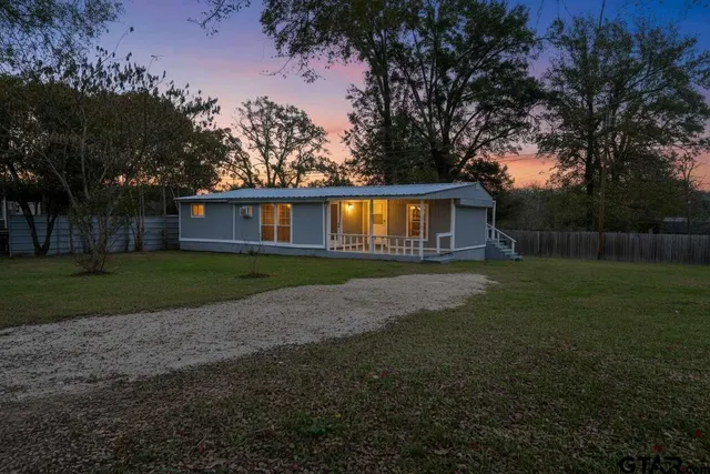 a view of house with backyard space and garden