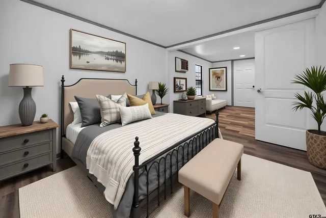 a bedroom with double bed and a potted plant