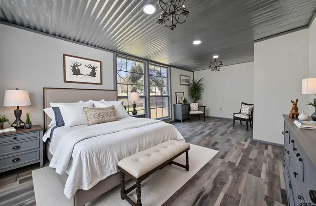 a spacious bedroom with a bed window and a table