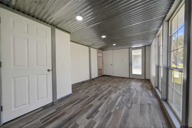 a view of hallway with wooden floor