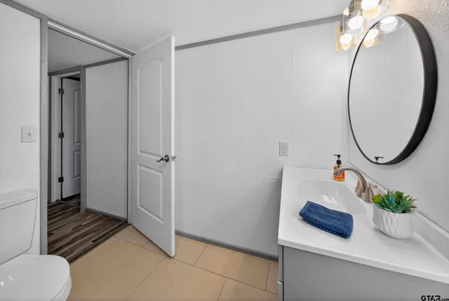 a bathroom with a sink a mirror and a shower