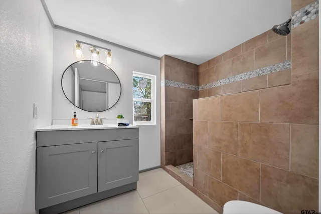 a bathroom with a sink mirror and toilet