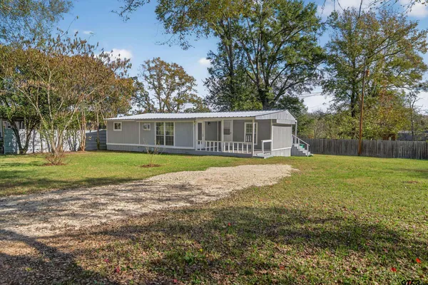 a view of house with backyard outdoor seating and lake view