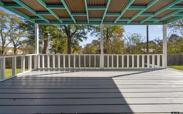 a white house with wooden fence