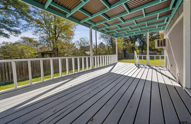 a view of balcony with wooden floor