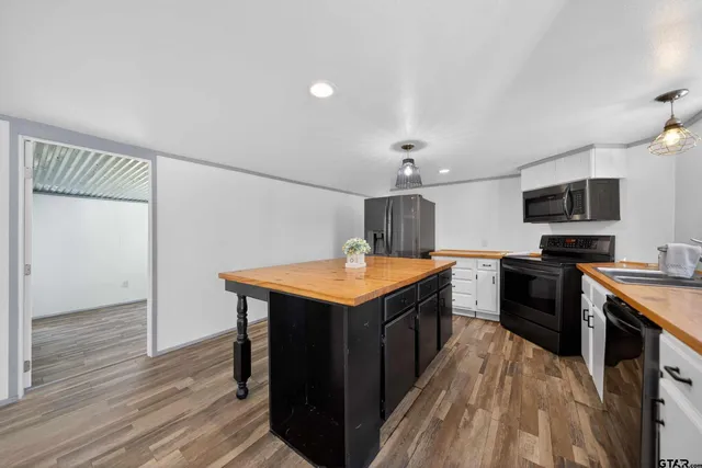 a kitchen with a stove a sink and a refrigerator