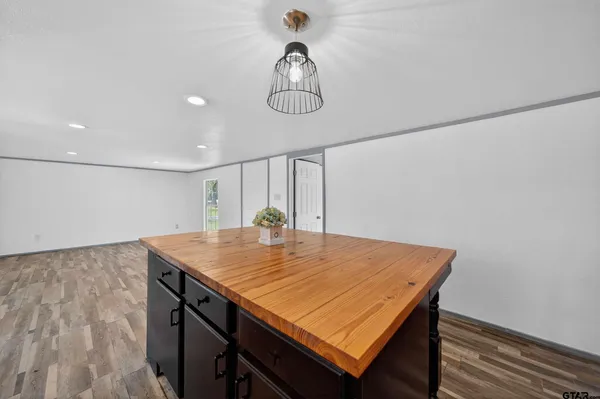 a view of a dining table chairs and wooden floor
