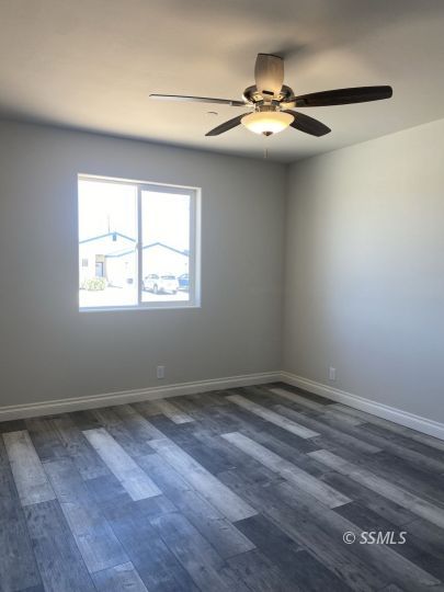 1521 Mayo Street Ridgecrest, CA 93555 - Photo 16 of 24 wooden floor in an empty room with a window