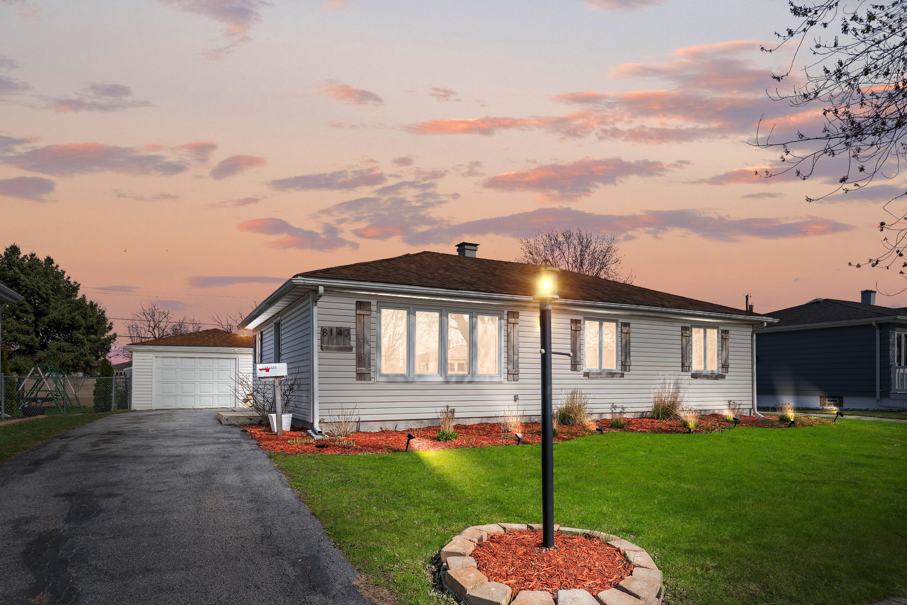 a front view of a house with a yard table and chairs