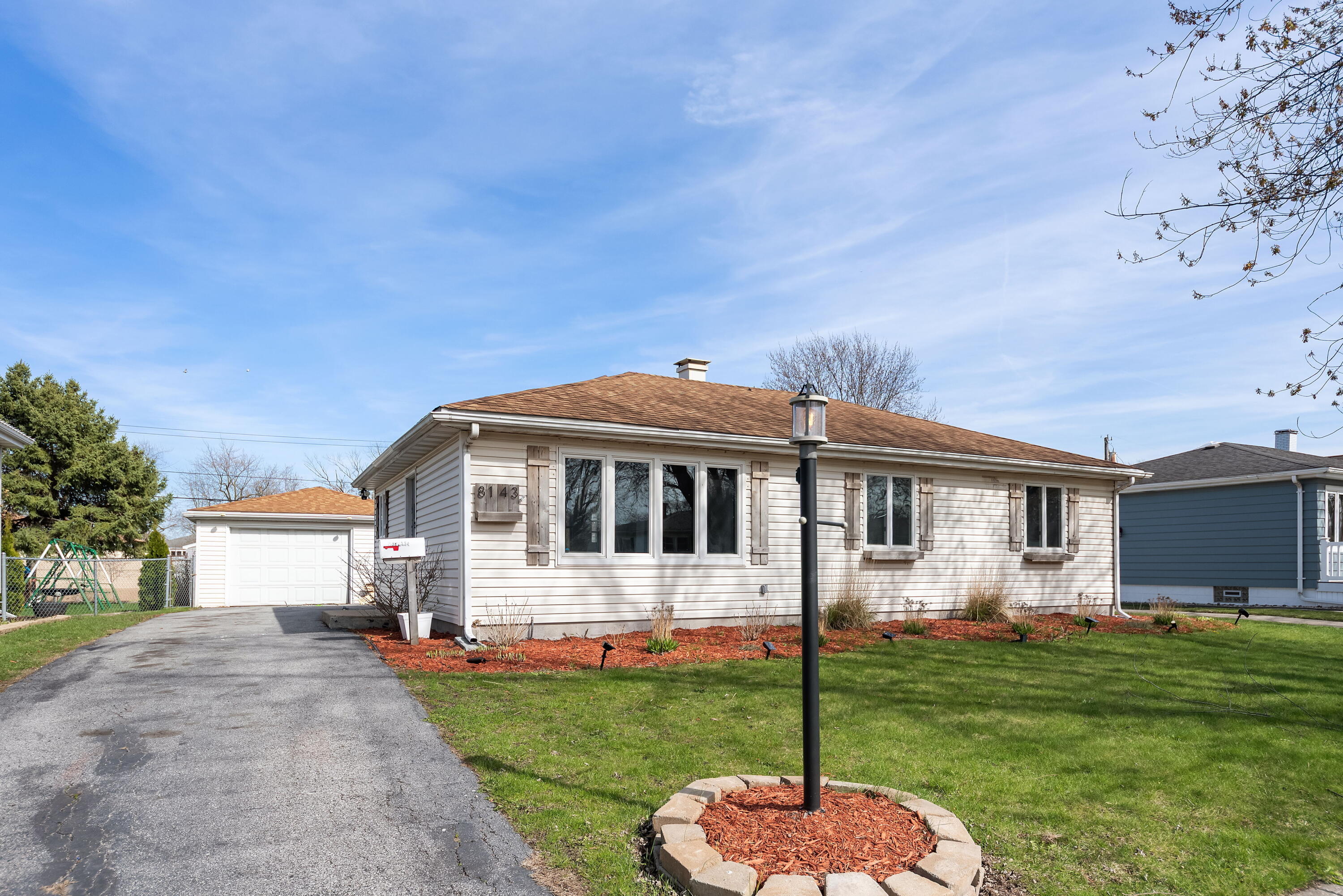 8143 Grace Street Highland, IN 46322 - Photo 2 of 18 a front view of a house with a garden and yard