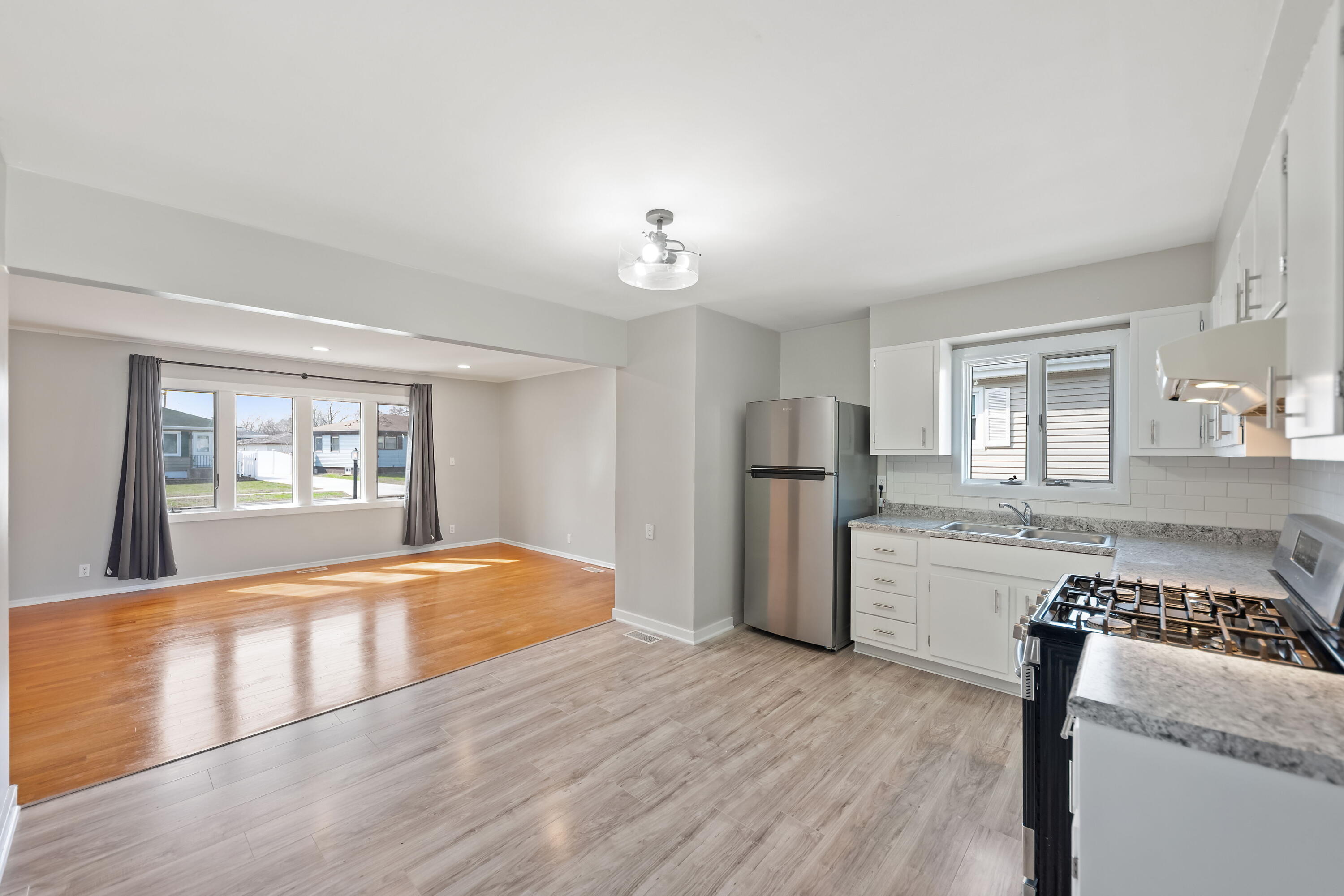 8143 Grace Street Highland, IN 46322 - Photo 10 of 18 a kitchen with a refrigerator and a stove top oven