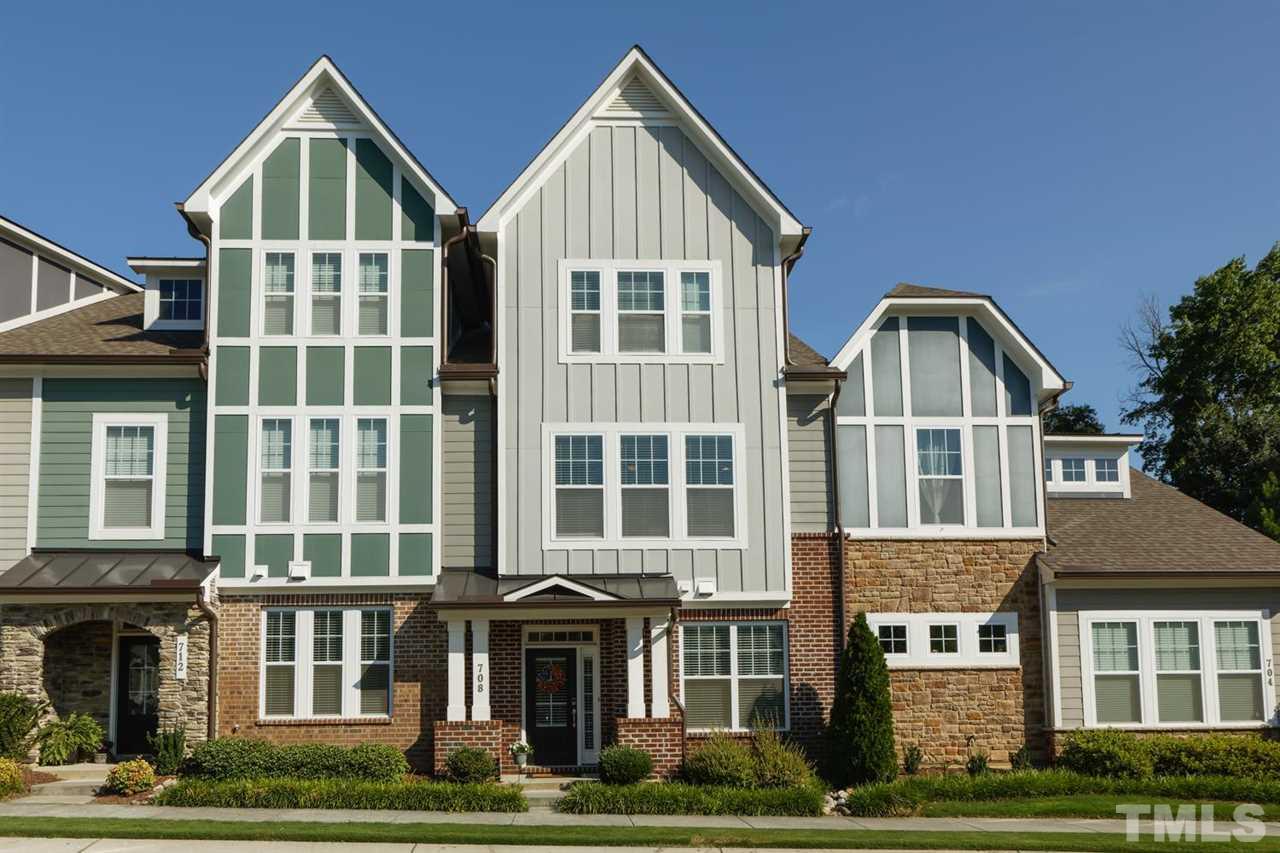 a front view of residential houses with yard