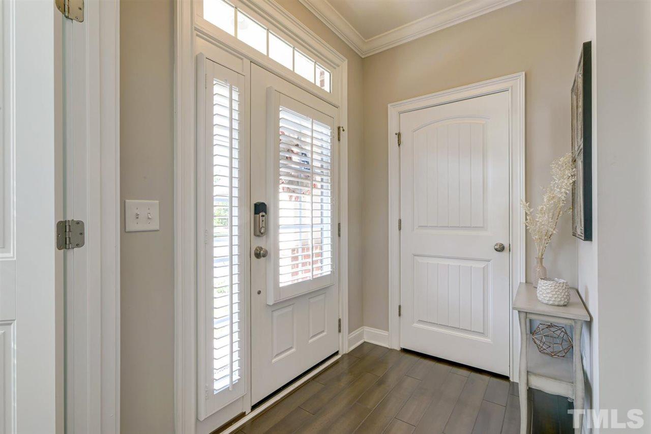 708 Fallon Grove Way Raleigh, NC 27608 - Photo 2 of 30 a view of an empty room with wooden floor and a window